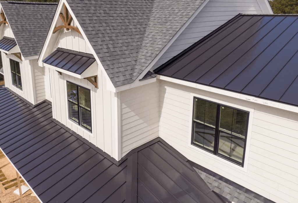 Modern home with dark metal roofing and gray shingles highlighting its pros and cons.